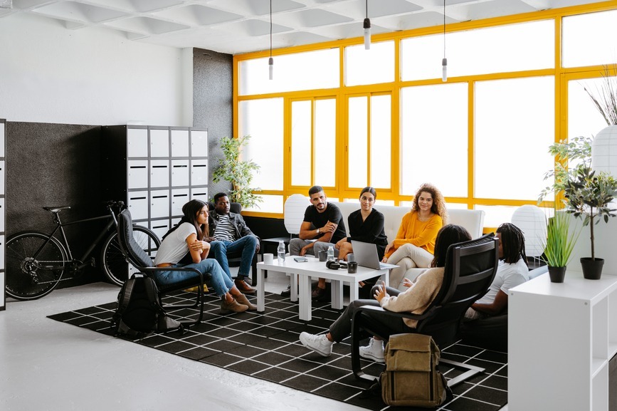 Group Of Diverse Colleagues Discussing Project In Modern Workspace